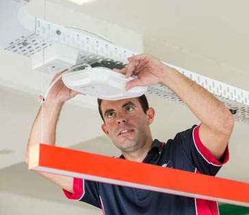 Elam Cabler installing a wireless unit in an office when relocating data and power cabling